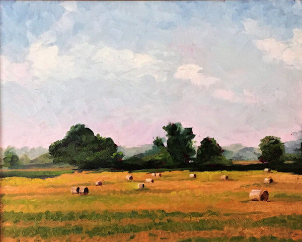 Bales of rolled hay under a beautiful painted sky in this plein air painting by Tom Smith